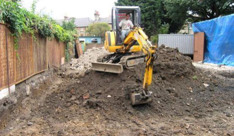Mini digger carrying out excavation